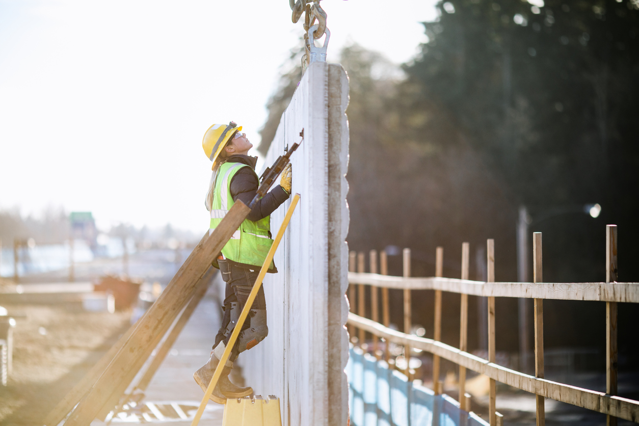 A female Caucasian laborer works on a large scale light-rail project in Washington state. A well paying trade job for a needed skillset.